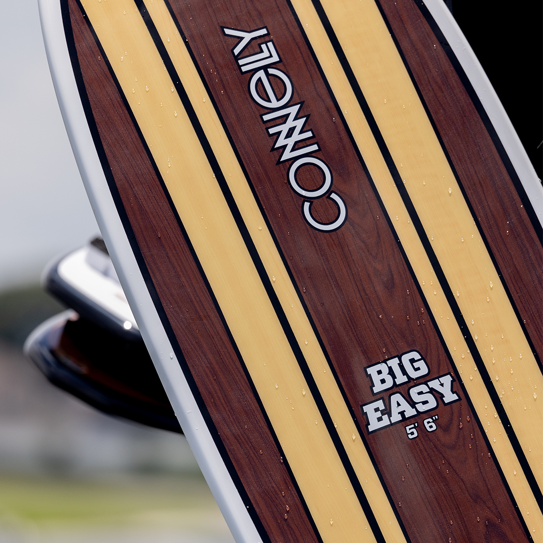 The top view of the Big Easy 5'6" wakesurfer, showcasing its wood-grain finish and Connelly branding.