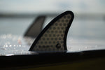 Close-up of the Seer wakesurf board’s fin, featuring a honeycomb pattern with “Seer 3.7” branding.