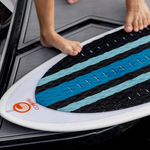 Close-up of the Scout wakesurf board's traction pad with black, blue, and gray diamond-patterned grip.