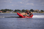 Side view of Big Easy 4, with four riders enjoying the ride while being pulled across the water.